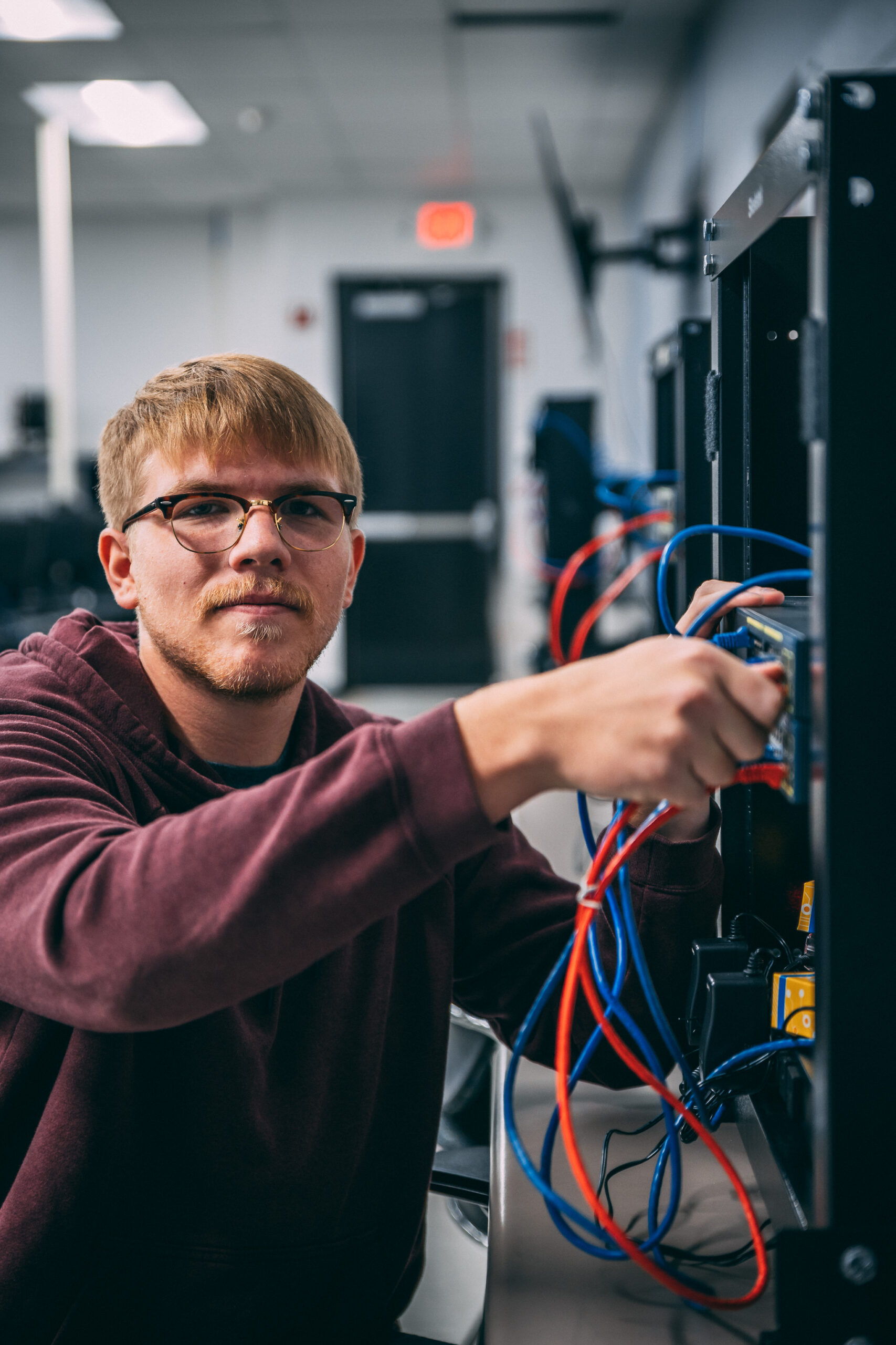 Student attaches network wires