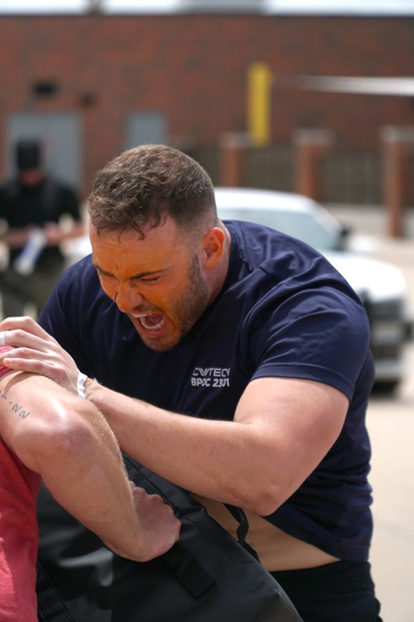 two police academy students practice hand-to-hand combat