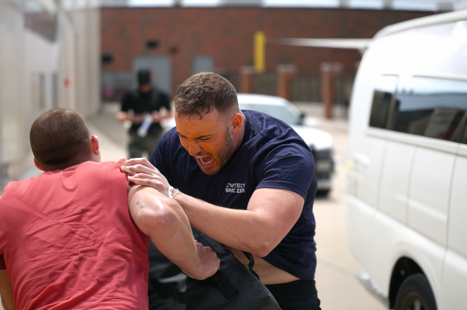 A police academy student practices self defense tactics with a trainer