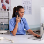 girl answering phone at medical desk